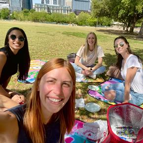 Four people having a picnic on Canva picnic mats in Austin