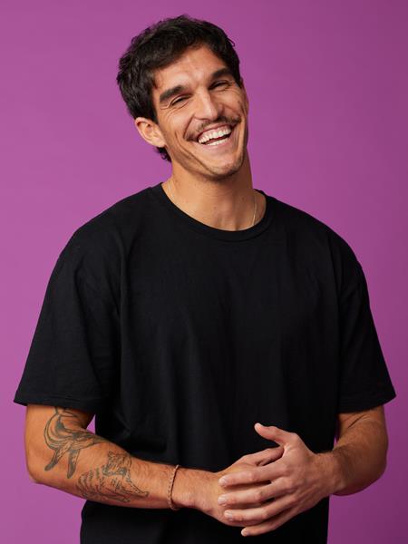 Man wearing black t-shirt smiling to the camera