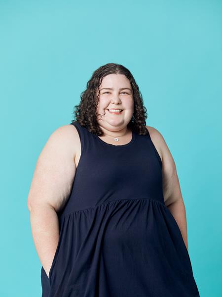Woman in dress smiling at the camera