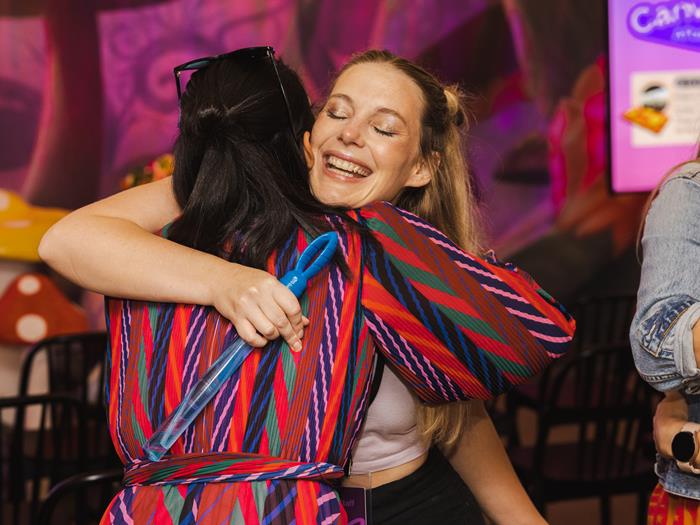 Two women hugging and smiling