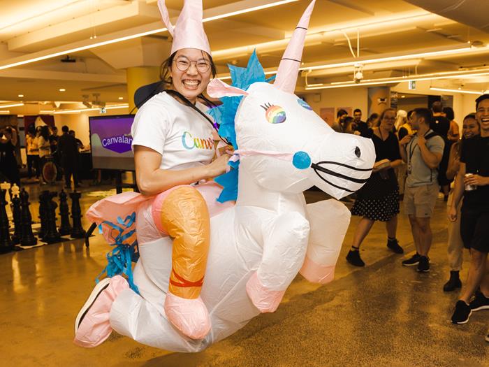 Women dressed up in a unicorn costumer with a Canva t-shirt