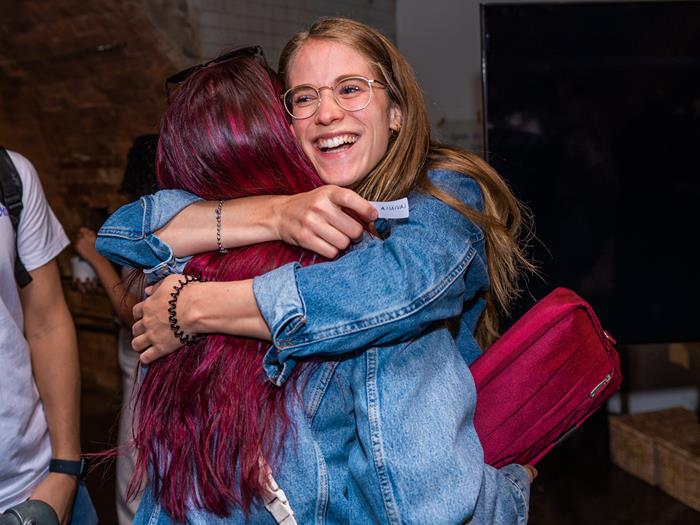 Two people hugging wearing denim jackets