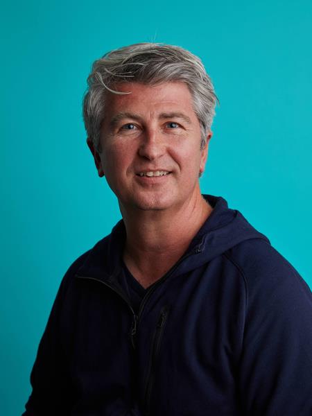 Man with black shirt smiling to the camera