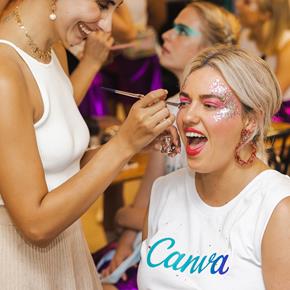 Girl with blonde hair having her makeup done for the Mardi Gras parade in Sydney. Sparkles on her face.