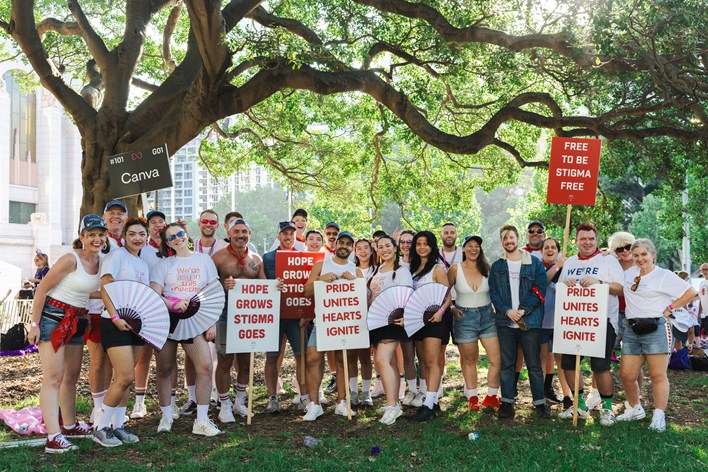 A group of Canvanauts holding signs and smiling for the camera.