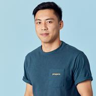 Man with dark blue t-shirt and black hair smiling at the camera