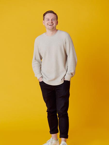 Man standing with hands in pockets