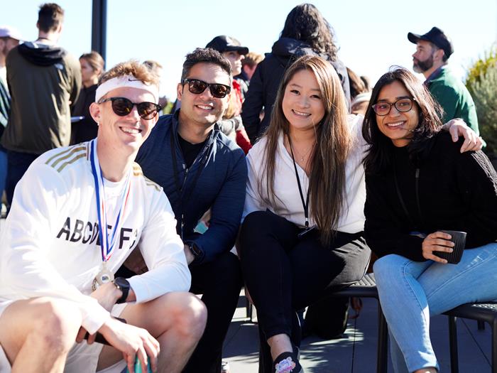 A group of colleagues on the rooftop at Sydney office smiling together for the photo