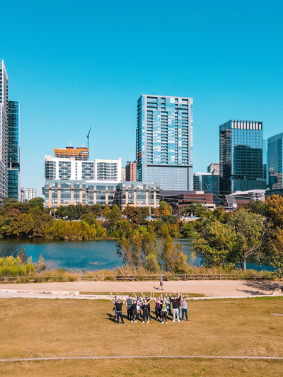 Team hike around Austin in front of the city