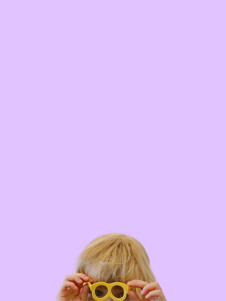 Blonde child with a pair of sunglasses on.