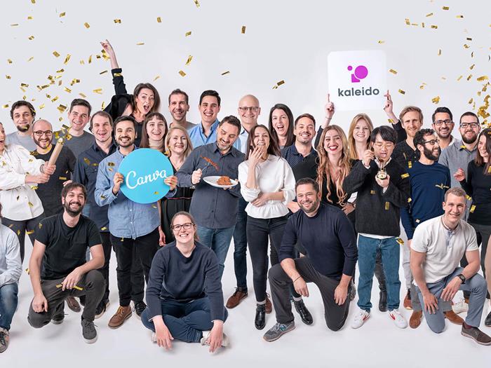 The Canva Austria x Kaleido team celebrating in a photo with confetti and a Canva sign